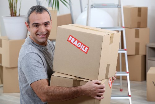 Local removal team packing household items for a move