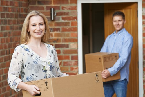 Professional movers carrying furniture through a residential property