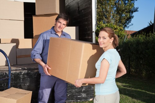 Professional movers handling furniture in a residential area of The Hale